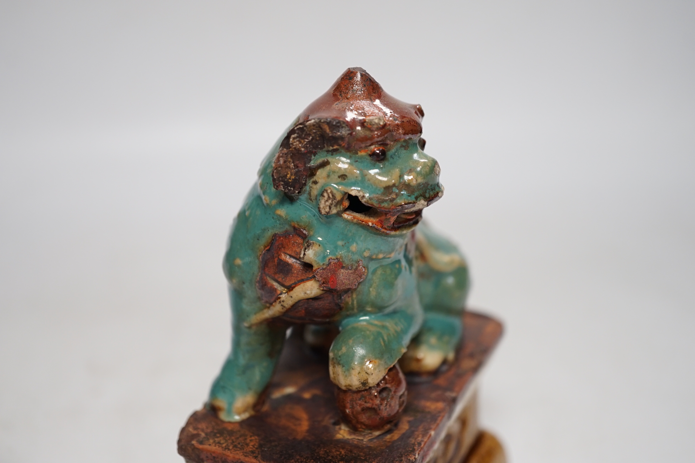 A 19th century Chinese Shiwan figure of a lion-dog, a celadon glazed shallow bowl and a cloisonné enamel censer, tallest 14cm (3)